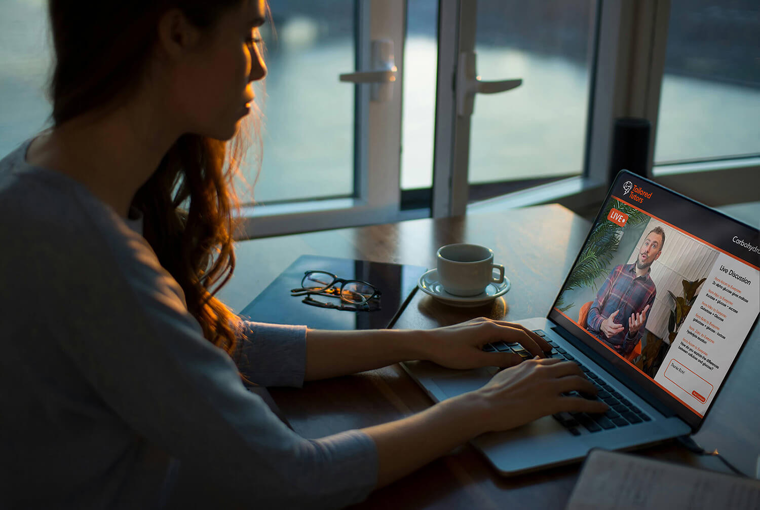 A level Biology student attending an online tutoring session at home on their laptop